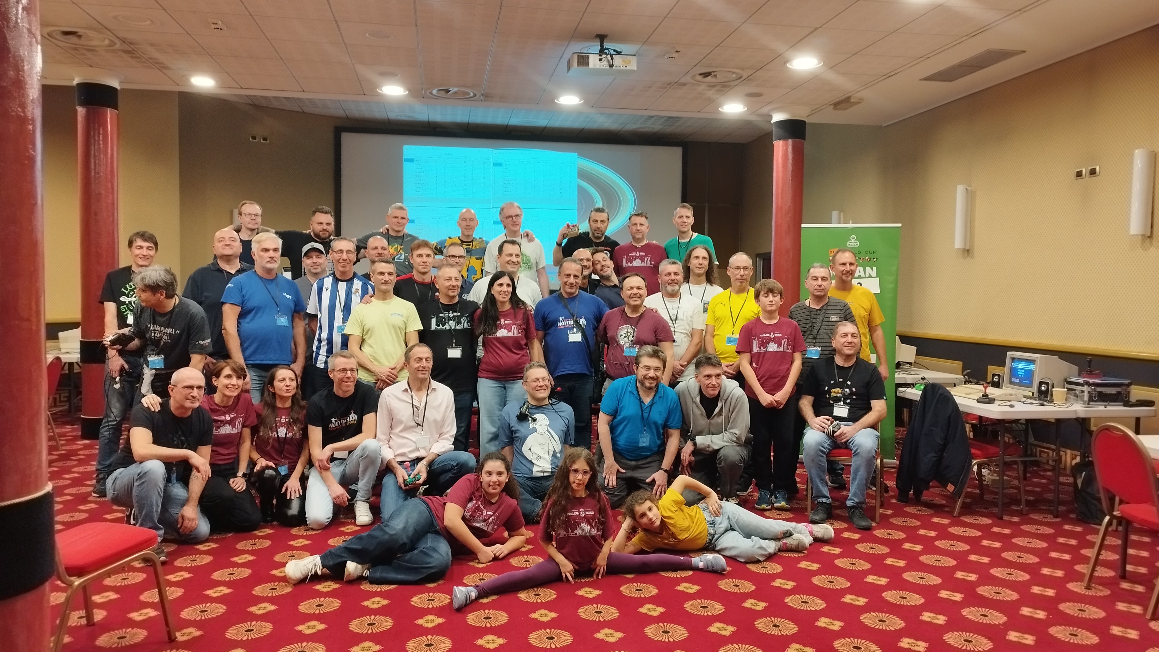 Kick Off 2 World Cup 2025 in Milan: large group photo of players and spectators in the tournament room.